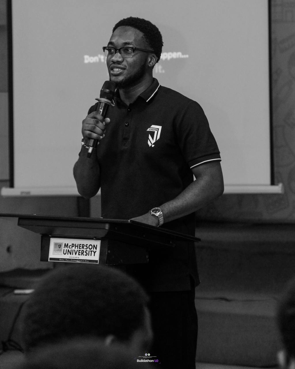 Oluwanifemi speaking at a podium during Buildathon 1.0 at McPherson University
